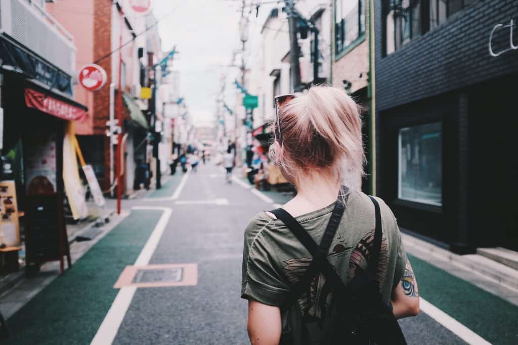 Back of a girl walking down a street